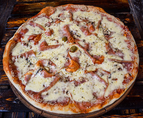 Delicious pizza on wooden stand