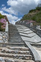 Fototapeta na wymiar Steps with stone slabs blue sky and white clouds background