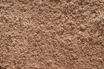 Red clay soil closeup as natural background