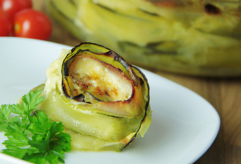 Grilled roll of zucchini stuffed with cheese and ham. Close up view.