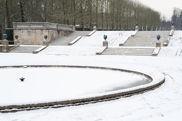 Stairs and frozen basin under the snow in Parc de Saint-Cloud, Paris, France
