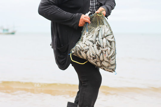 Fisherman carrying a fish bag