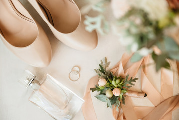 Bridal morning details composition. Top view of bride's garter, bouquet of field flowers with...