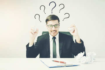 caucasian business man stress and crumpled paper