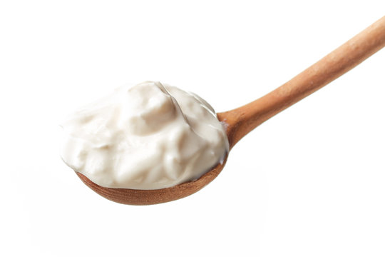 Sour Cream In Spoon Isolated On White