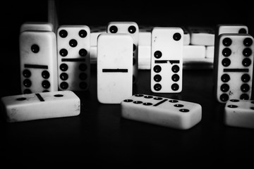 pieces of domino principle concept in black and white effect