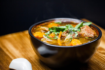 Hot and rich flavor beef stew in the bowl on wooden table 