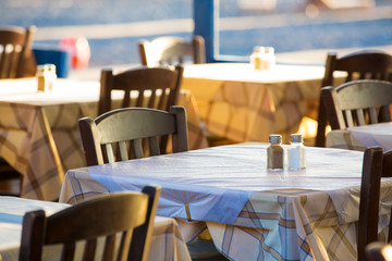 Outdoor cafes in coastline resort Kamari in Santorini Greece