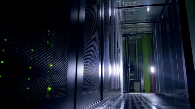 Green LEDs glow in data storage cabinets at nighttime. 