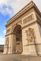 Fototapeta na wymiar PARIS, FRANCE - DECEMBER 11, 2014: The Arc de Triomphe de l'Etoile is one of the most famous monuments, View of the Champs-Elysees Avenue is full of stores, cafes and restaurants.