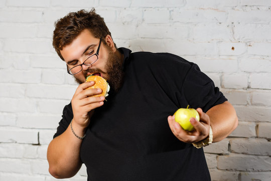 Fat Man Greedily Eating Hamburger, on white background