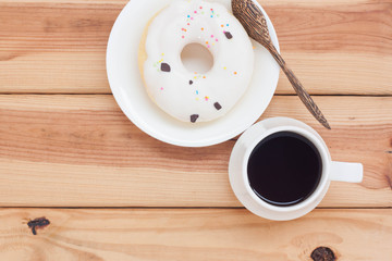 Sweet donut and black coffee hot morning beverage or break time.