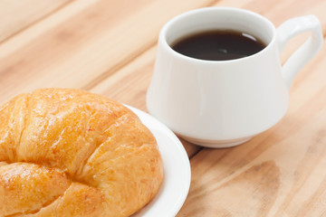 Croissant and black coffee hot morning beverage or break time.