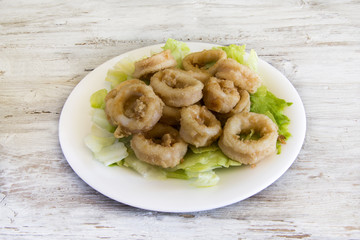 Fried calamari served on a plate.