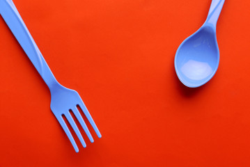 plastic spoon isolated on orange background.