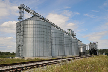 Fototapeta na wymiar Agricultural Silos. metal grain facility with silos.