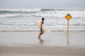 cautious surfer moves away from dangerous spots