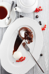 Chocolate flan with ice cream and berries