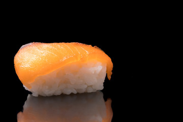 Sushi, japanese food, rice with salmon on black background.