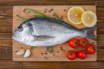Fresh dorado on wooden background
