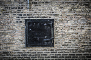 Brick wall with black vent