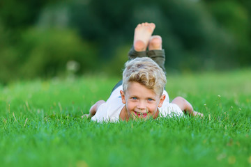 young boy playing in the grass