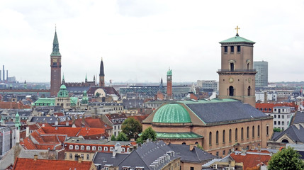 Church of Our Lady and cityscape, aerial view from the platform at the top of the Rundetaarn or Round Tower in old town, cloudy weather, Copenhagen, Denmark