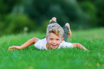young boy playing in the grass