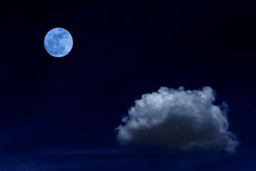 Blue moon and cloud  in the dark sky at night