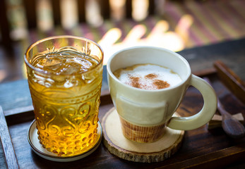 a cup of coffee on wood table