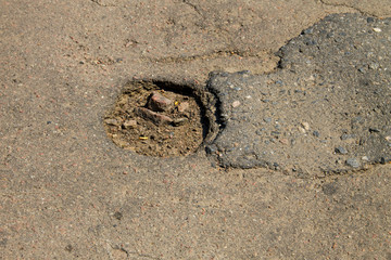 Damaged asphalt road with pothole