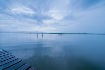 wooden pier and sea in morning of rainy day.