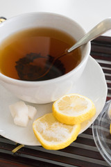 Hot tea with lemon and sugar