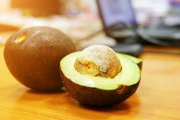 Avocado on an Office Wooden Desk, selective focus