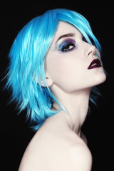 Young beautiful woman with colorful fancy make-up and blue wig