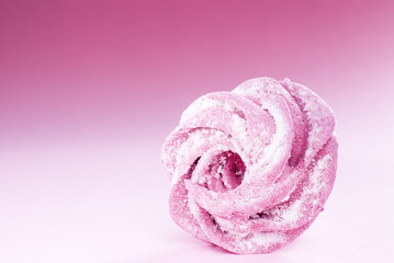 delicate pink marshmallow in powdered sugar, on a pink background