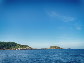 Fototapeta na wymiar Cape Higuer Lighthouse from Sea View