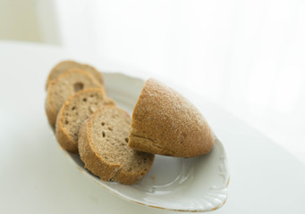 Black cereal chopped on a plate of bread