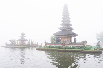 Temple on the lake in the fog