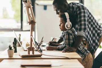 father and son drawing with tablet