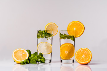 Water with lemon, orange and mint isolated