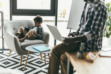 father and son using gadgets