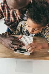 Fototapeta na wymiar father and son with calculator