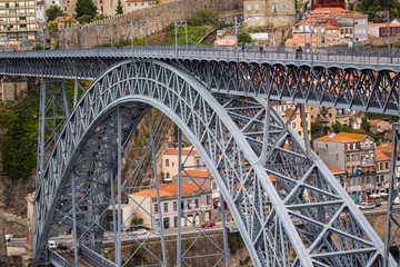 Porto, Portugal - July 2017. View of the iconic Dom Luis I bridge crossing the Douro River, and the historical Ribeira and Se District in the city of Porto, Portugal. Unesco World Heritage Site.