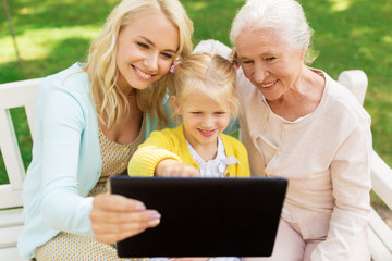 mother, daughter and grandmother with tablet pc