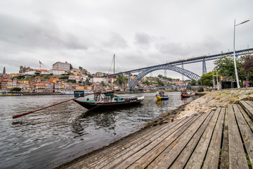 Fototapeta na wymiar Porto, Portugal - July 2017. View of the iconic Dom Luis I bridge crossing the Douro River, and the historical Ribeira and Se District in the city of Porto, Portugal. Unesco World Heritage Site.
