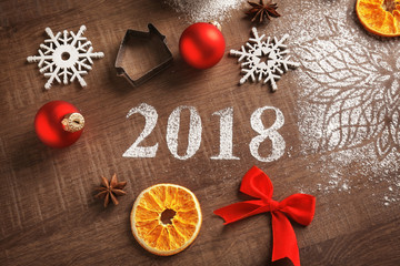 Cookie cutter, Christmas decor and 2018 made of flour on wooden table