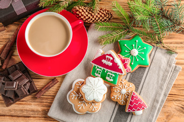 Tasty Christmas homemade cookies and cup of coffee on table