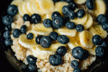 Healthy vegetarian breakfast. Oatmeal with banana and blueberry
