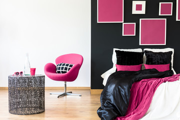 Pink chair in girly bedroom